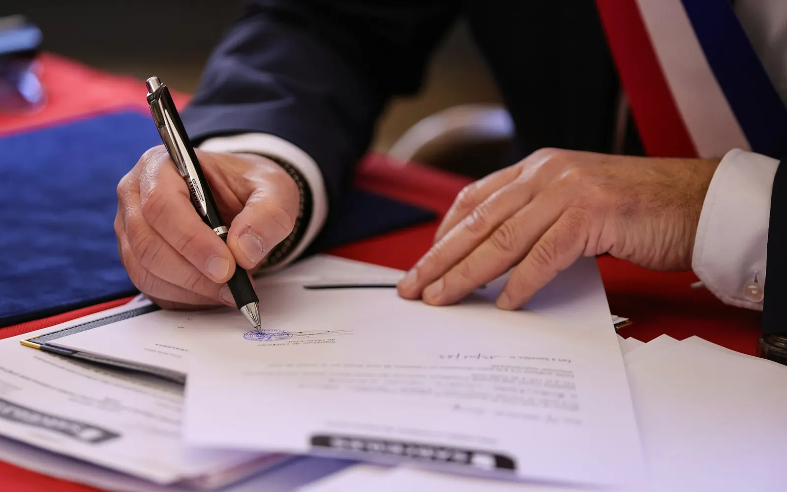 Real estate agreement being signed for a property collaboration discussion